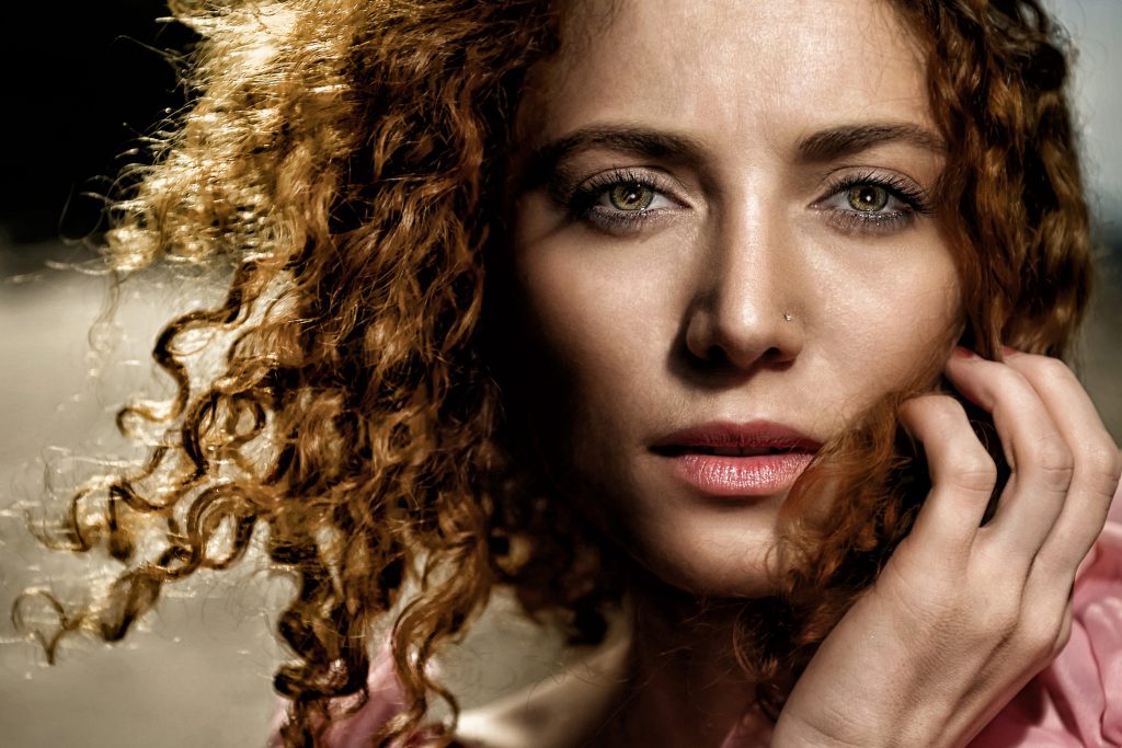 lose-up portrait of a woman with curly hair illustrating facts about the face