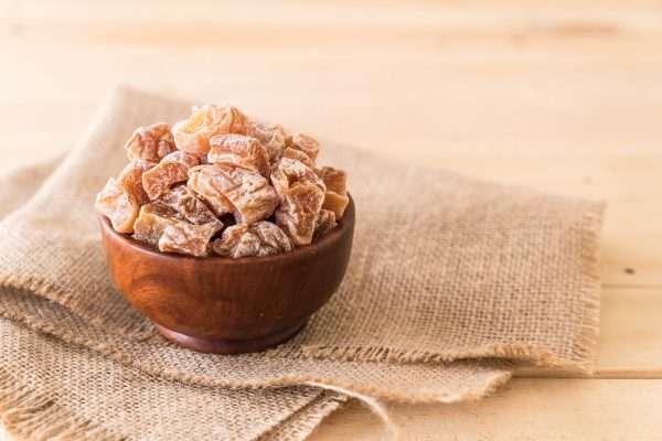 ginger chews for nausea in a wooden bowl